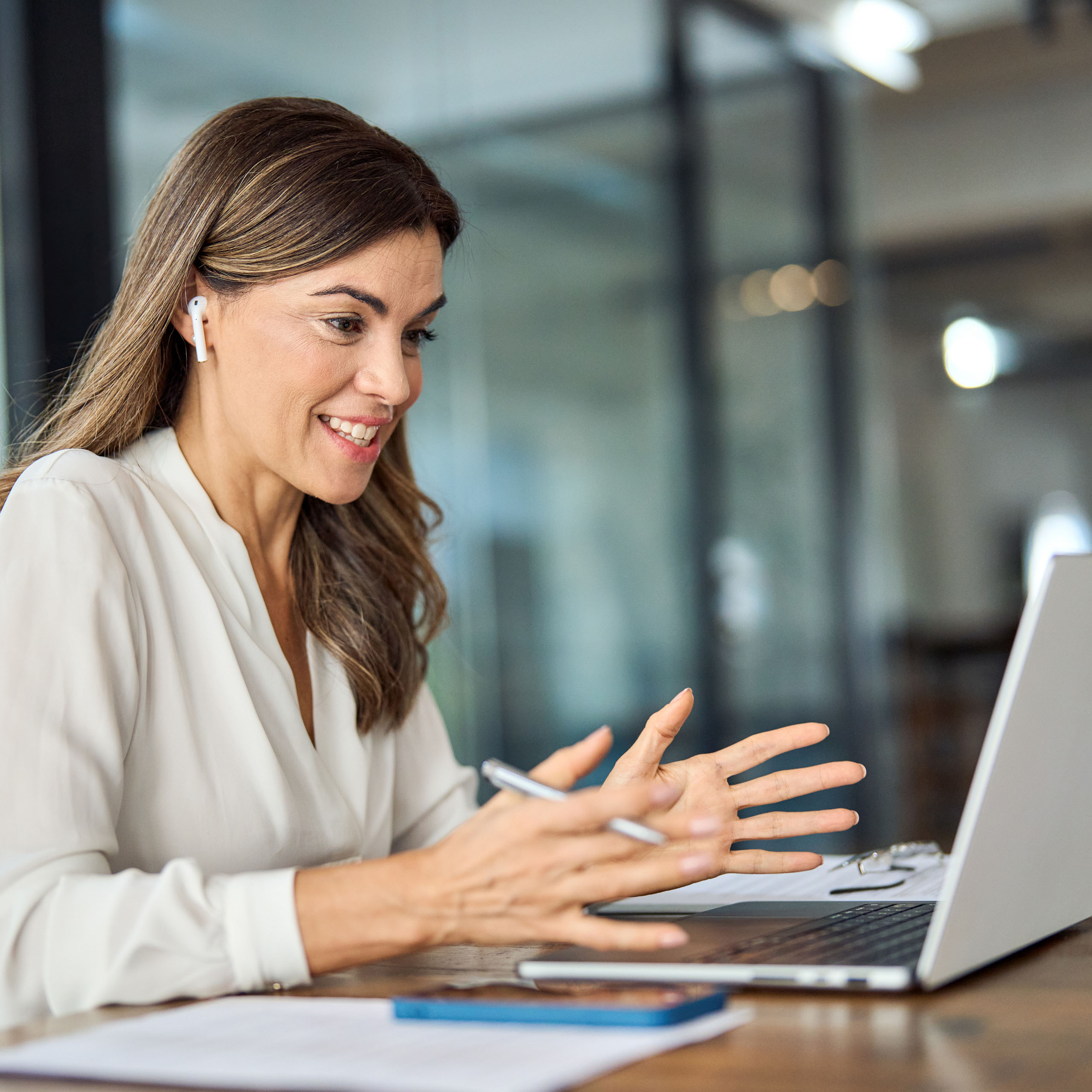 Attractive woman in neutral coloured shirt on a video conference call