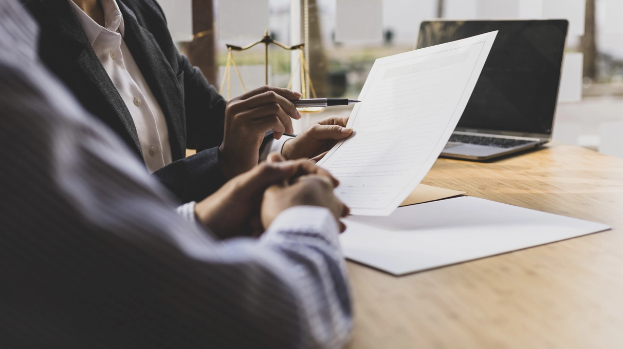 Two people reviewing paperwork at a desk