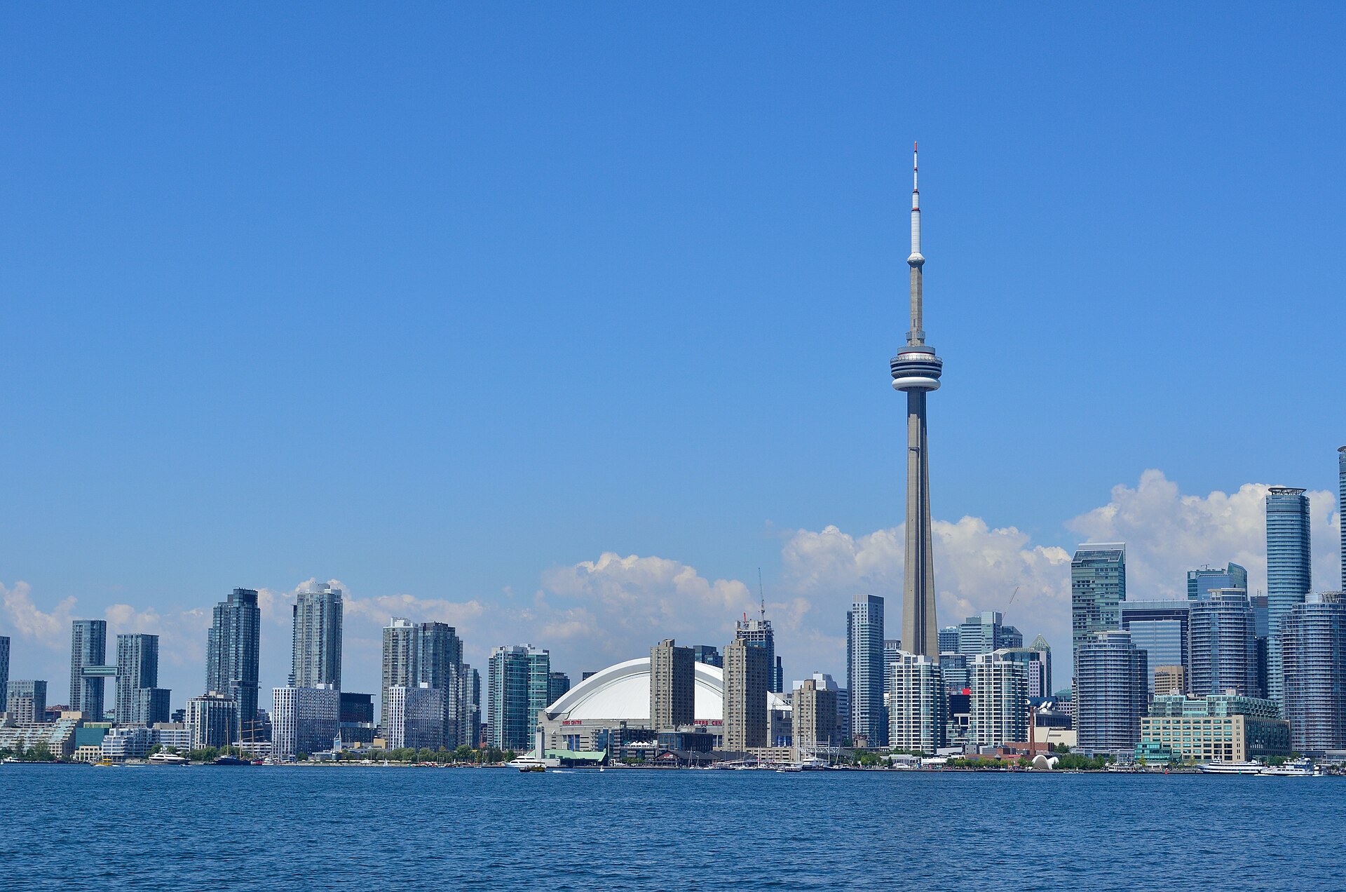 The Toronto skyline with the CN Tower and Rogers Centre across Lake Ontario.